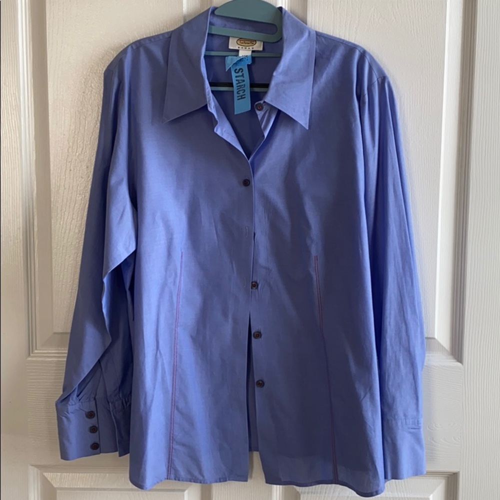 Blue button down shirt with red stitching.